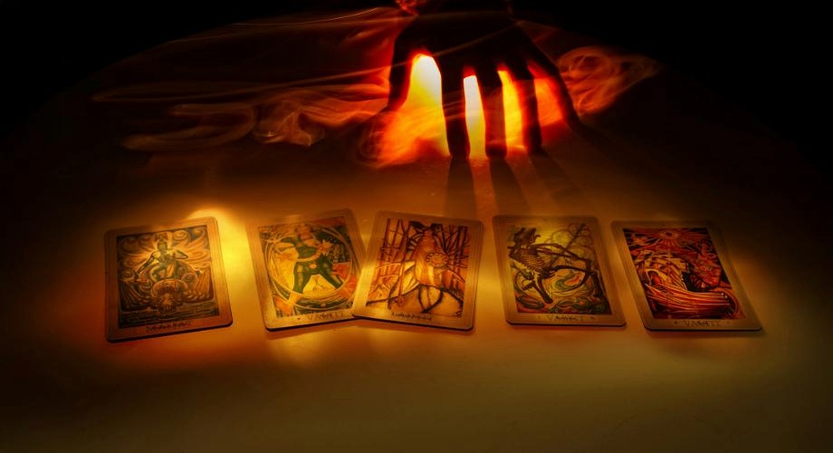 Hands pointing to a deck of cards